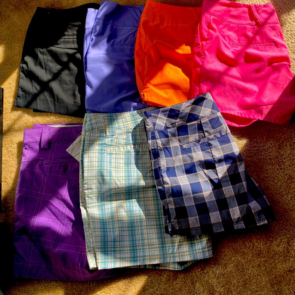 7 pairs womens golf shorts- size 12. Assorted brands.